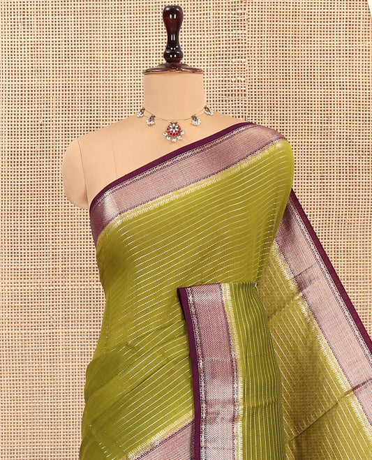 Green Assam Silk Saree, Subtly Sparkled with Zari Stripes on Its Body, Complemented by Contrast Zari Border, Pallu Depicts Zari Stripes, and Paired with a Contrast Blouse