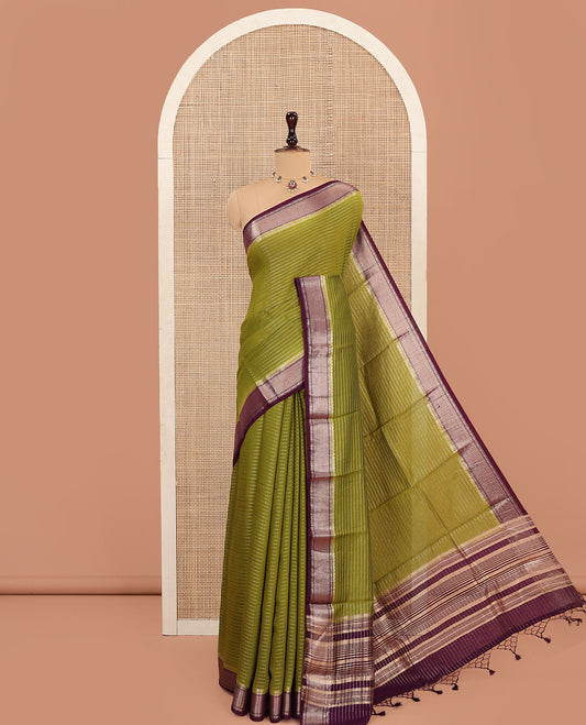 Green Assam Silk Saree, Subtly Sparkled with Zari Stripes on Its Body, Complemented by Contrast Zari Border, Pallu Depicts Zari Stripes, and Paired with a Contrast Blouse