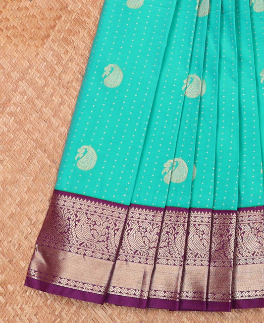 Turquoise Budget Silk Saree Steeped with Small Buttas and Paisley Buttas, Complemented by a Contrast Traditional Zari Motifs Border, Intricate Pallu, and Paired with a Contrast Blouse