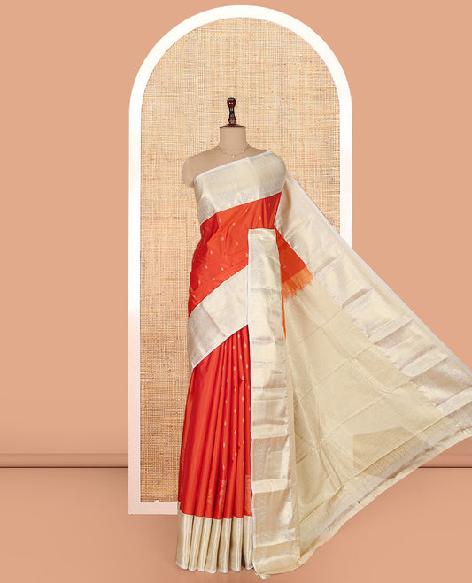 Rust Orange Budget Silk Saree, Gleamed Up with Zari Buttas on Its Body, Complemented by a Contrast Traditional Zari Design Border, Grandly Decked Up Pallu, and Paired with a Contrast Blouse