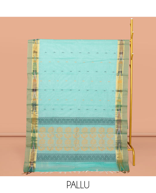 Turquoise Kanchi Cotton Saree, Showcasing Buttas All Over Its Body, Complemented by a Contrast Ikkat Border, Pallu of Floral Design, and Paired with a Matching Blouse