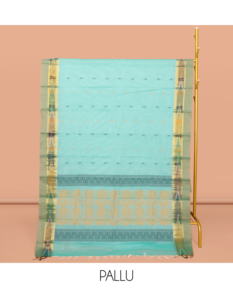 Turquoise Kanchi Cotton Saree, Showcasing Buttas All Over Its Body, Complemented by a Contrast Ikkat Border, Pallu of Floral Design, and Paired with a Matching Blouse