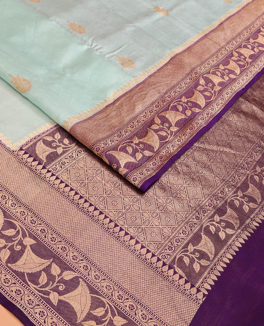 Baby Blue Raw Mango Silk Saree Subtly Sparked with Buttas, Complemented by a Contrast Traditional Zari-Designed Border, Featuring a Zari-Elevated Jaal-Designed Pallu, Paired with a Contrast Blouse
