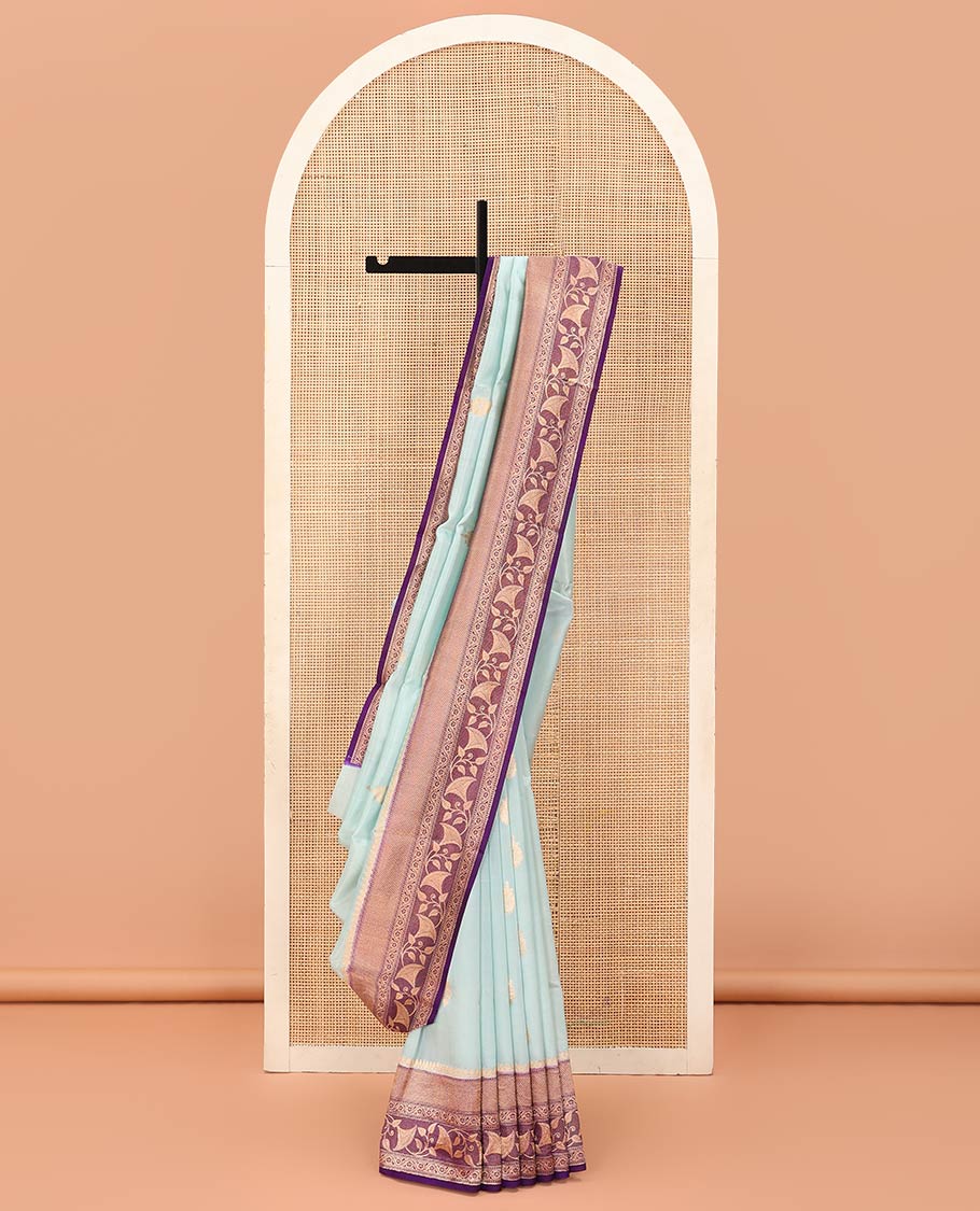 Baby Blue Raw Mango Silk Saree Subtly Sparked with Buttas, Complemented by a Contrast Traditional Zari-Designed Border, Featuring a Zari-Elevated Jaal-Designed Pallu, Paired with a Contrast Blouse
