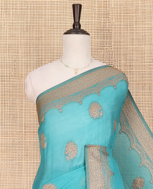 Blue Fancy Georgette Saree Sparsely Sparkled with Zari Buttas, Hazily Zari Woven Border of Scallop Designs, Zari Woven Pallu of Ogee Patterns, and Paired with a Matching Blouse