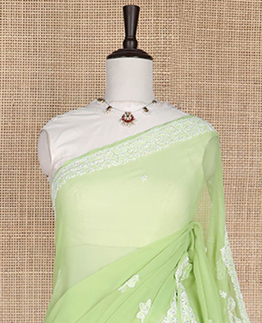 Light green floral motifs embroidery georgette saree with self embroidered border & floral thread embroidery pallu