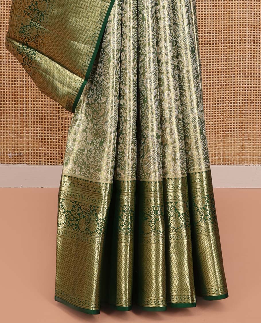 Green Kanchipuram Tissue Silk Saree, Majestically Detailed with Jacquard Designs on Its Body, Highlighted by a Zari Border of Jaal, and Floral Designs, Intricately Designed Pallu, and Paired with a Matching Blouse