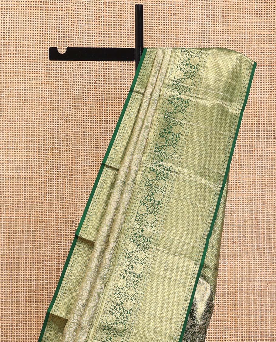 Green Kanchipuram Tissue Silk Saree, Majestically Detailed with Jacquard Designs on Its Body, Highlighted by a Zari Border of Jaal, and Floral Designs, Intricately Designed Pallu, and Paired with a Matching Blouse