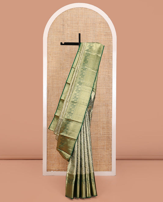 Green Kanchipuram Tissue Silk Saree, Majestically Detailed with Jacquard Designs on Its Body, Highlighted by a Zari Border of Jaal, and Floral Designs, Intricately Designed Pallu, and Paired with a Matching Blouse