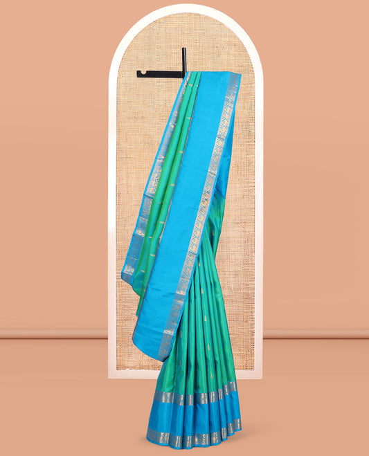 Green Kanchipuram Silk Saree, Ornamented with Zari Buttas, Complemented by Contrast Rettai Pettu Border of Rekku, Muthu, and Mayil Designs, Jaal Pallu, and Contrast Blouse