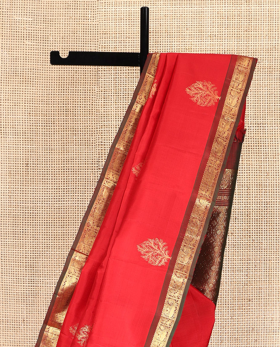 Red Kanchipuram Silk Saree, Decked Up with Zari Buttas All Over Its Body, Complemented by a Contrast Border of Ara Bogudi, Yaanai, and Annam Designs, Grand Pallu, and Paired with a Contrast Blouse