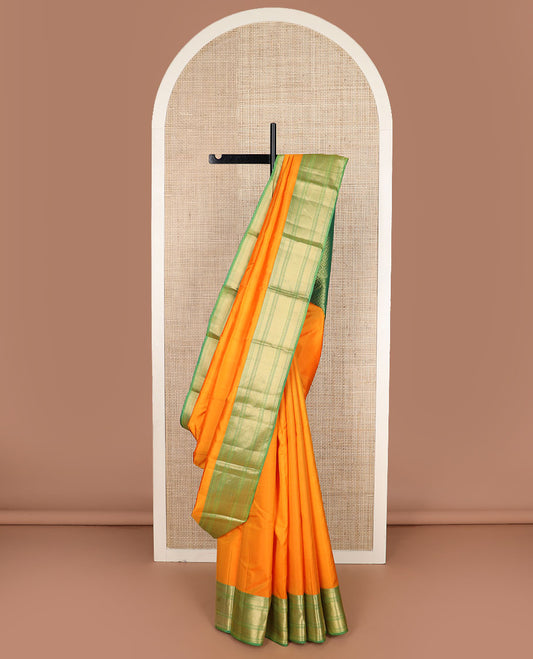 Orange plain Kanchipuram silk saree, contrast border of rudraksham, mayil kann & zari stripes & jaal pallu