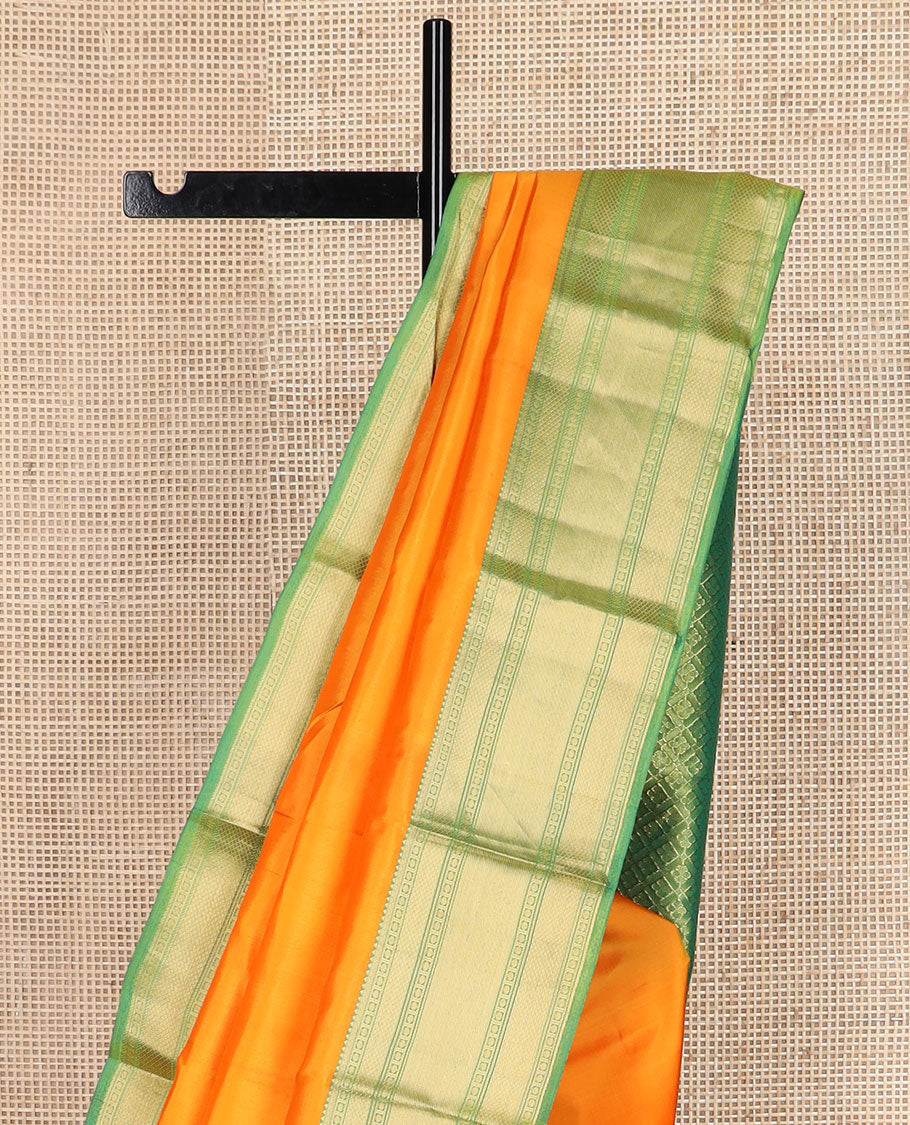 Orange plain Kanchipuram silk saree, contrast border of rudraksham, mayil kann & zari stripes & jaal pallu