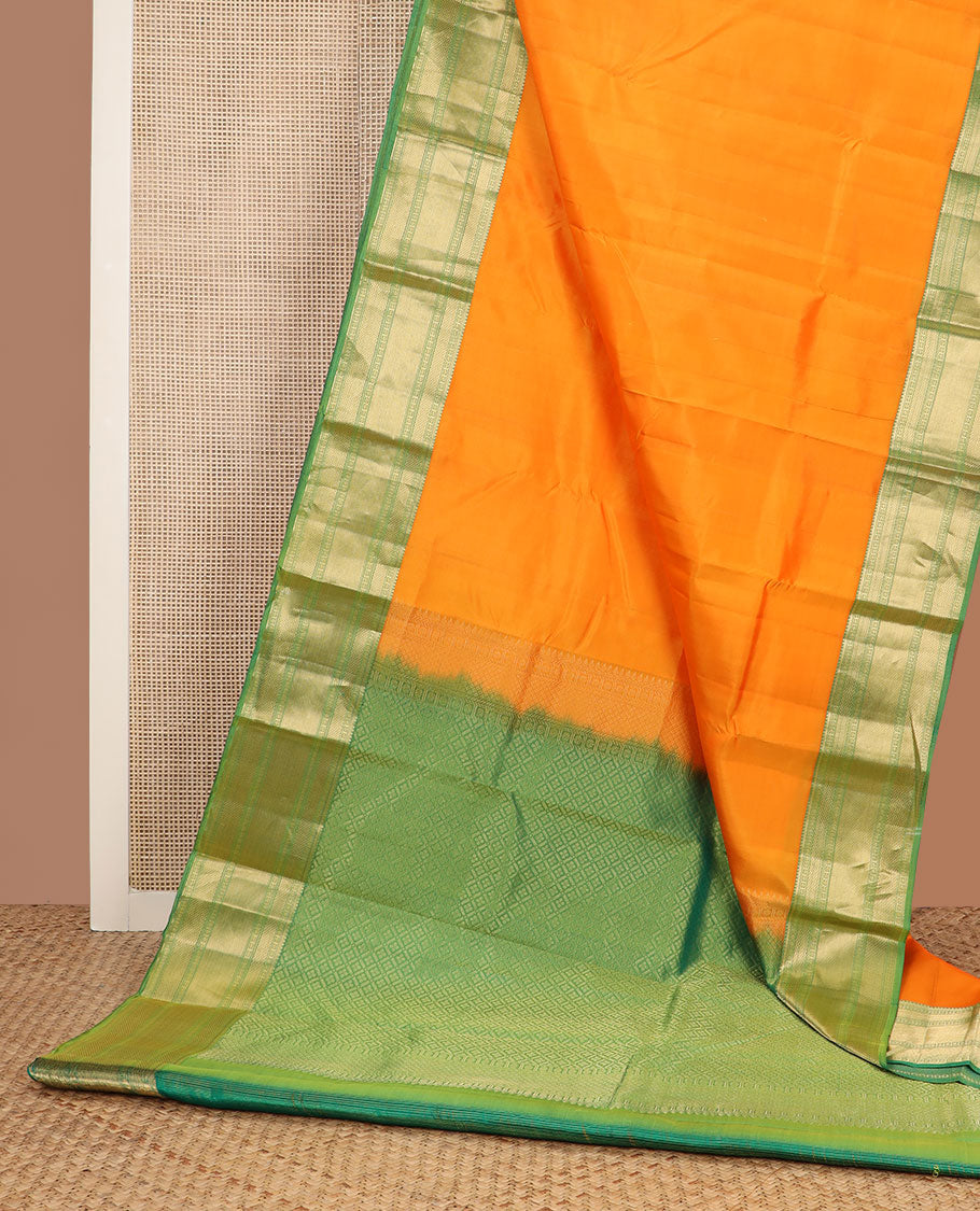 Orange plain Kanchipuram silk saree, contrast border of rudraksham, mayil kann & zari stripes & jaal pallu