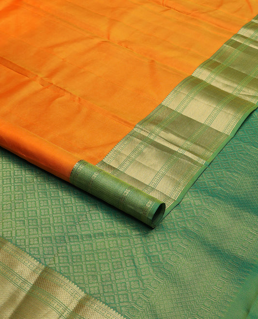 Orange plain Kanchipuram silk saree, contrast border of rudraksham, mayil kann & zari stripes & jaal pallu