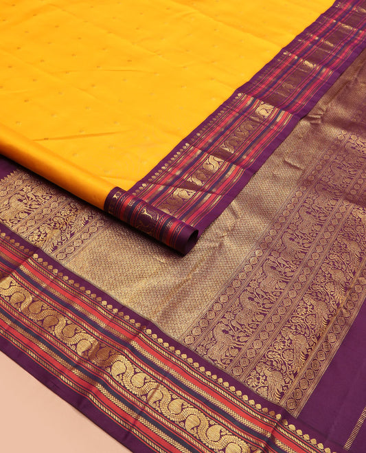 Yellow zari buttas Kanchipuram silk saree, contrast border of thilakam mokku, banaras, kathir, and dhavana manga designs, and mayil kann design pallu