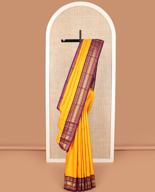 Yellow zari buttas Kanchipuram silk saree, contrast border of thilakam mokku, banaras, kathir, and dhavana manga designs, and mayil kann design pallu