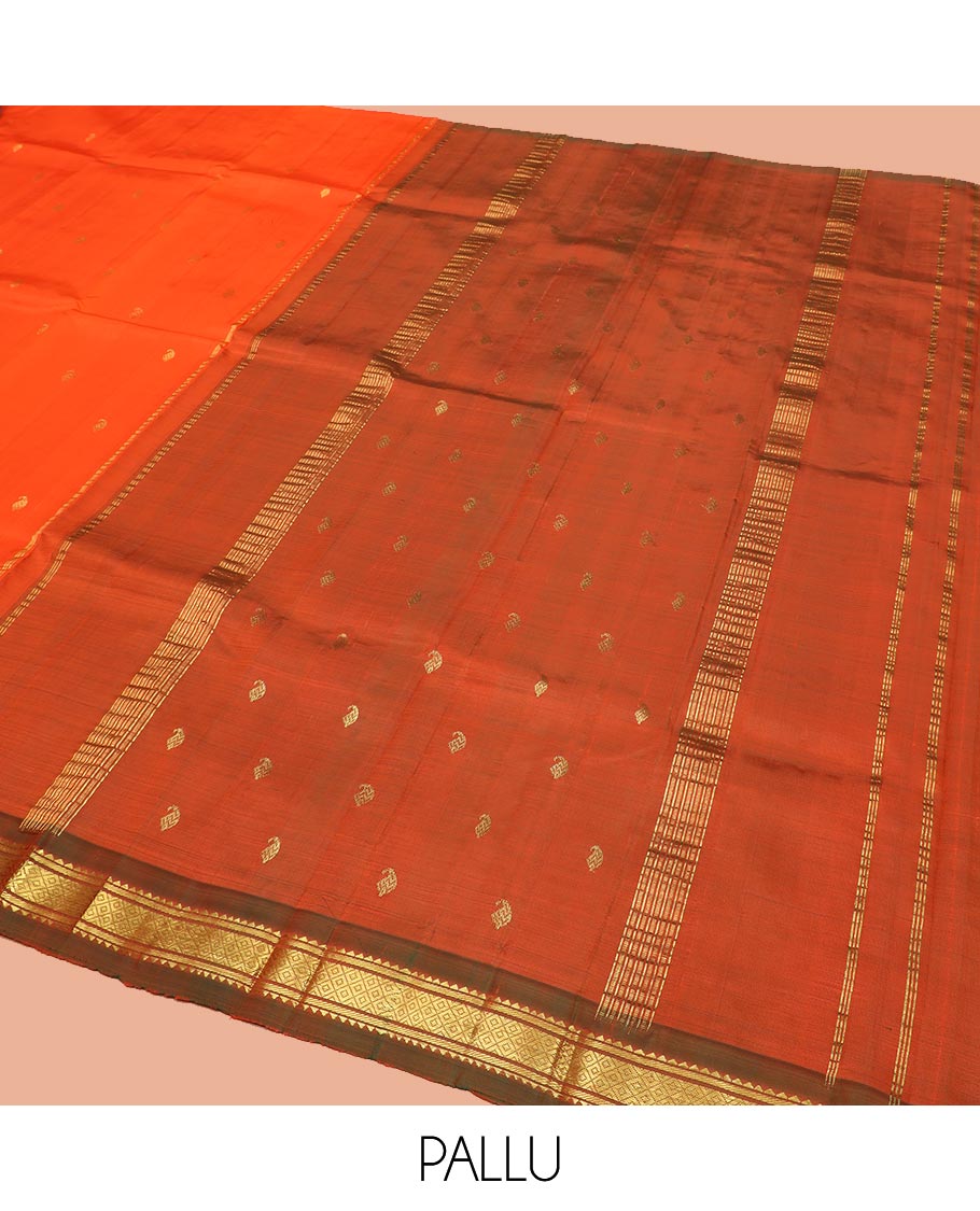 Orange Kanchipuram Silk Saree Mesmerized with Zari Buttas All Over Its Body, Complemented by a Contrast One-Sided Border of Rekku, Banaras, and Mayil Kann Designs, Pallu of Zari Stripes, and Comes Without a Blouse