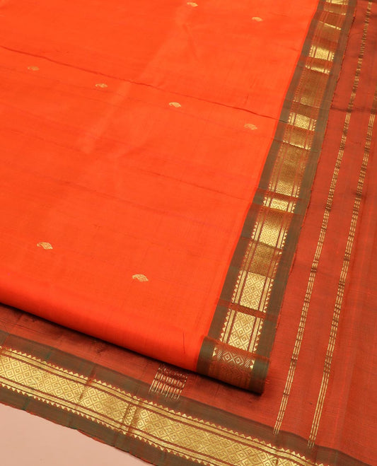 Orange Kanchipuram Silk Saree Mesmerized with Zari Buttas All Over Its Body, Complemented by a Contrast One-Sided Border of Rekku, Banaras, and Mayil Kann Designs, Pallu of Zari Stripes, and Comes Without a Blouse