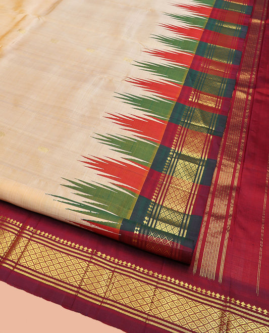 Sandal Kanchipuram Silk Saree Sparsely Sparkled with Zari Buttas, Complemented by Contrast One-Sided Thazampoo Rekku Border of Paneer Sombu, Banaras, and Mayil Kann Designs, Grandly Woven Pallu Steeped with Floral Designs, and Comes Without a Blouse