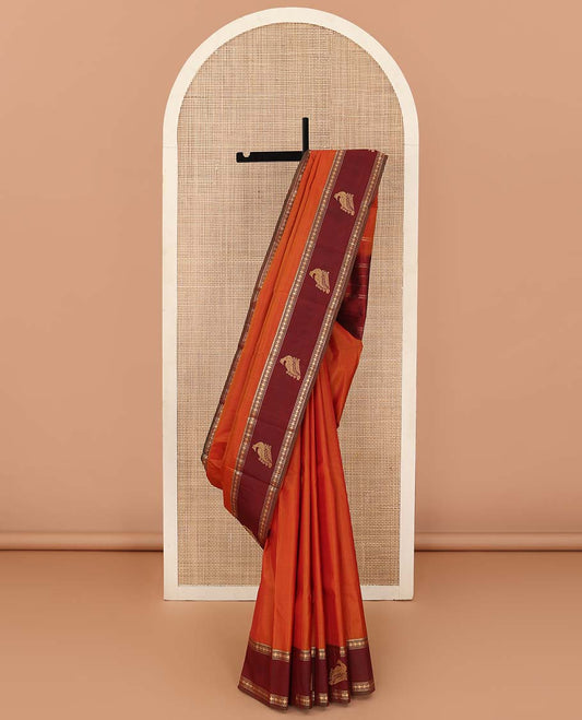 Orange plain Kanchipuram silk saree, contrast border of rekku, muthu, rudraksham and mayil, and zari striped pallu