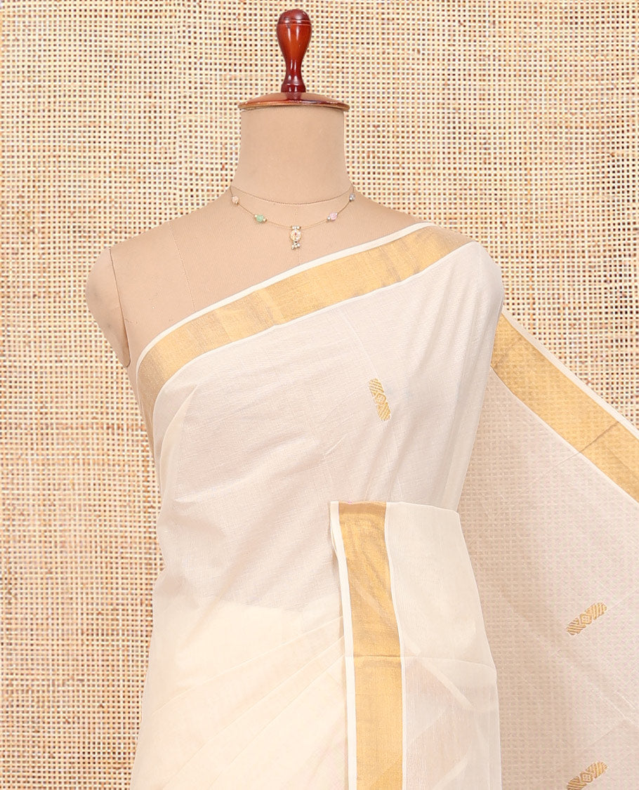 Cream Kerala Cotton Saree, Graced with Zari Buttas All Over Its Body, a Zari Bavanji Border, Pallu Woven with Peacock Designs, and Paired with a Matching Blouse