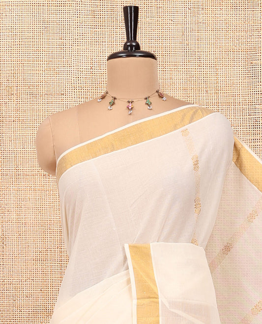 Cream Kerala Cotton Saree, Highlighted by Zari Stripes All Over Its Body, a Subtle Bavanji Border, Pallu Steeped with Peacock Designs, and Paired with a Matching Blouse