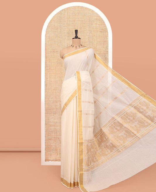 Cream Kerala Cotton Saree, Highlighted by Zari Stripes All Over Its Body, a Subtle Bavanji Border, Pallu Steeped with Peacock Designs, and Paired with a Matching Blouse
