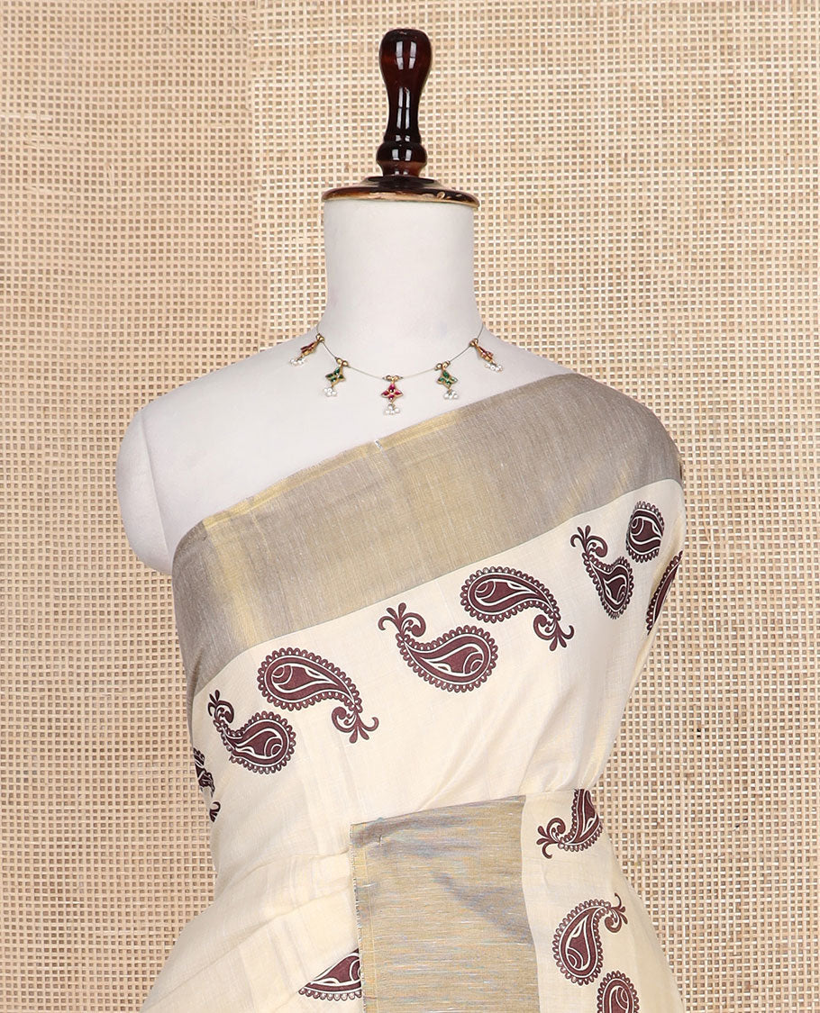 Cream paisley buttas printed Kerala saree, bavanji border, and pallu of paisleys