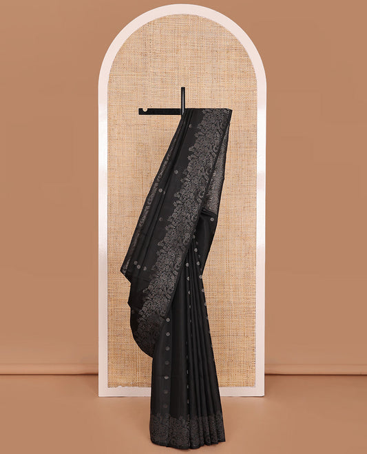 Black Mayuri Soft Silk Saree Gleamed Up with Floral Zari Buttas Across Its Body, Highlighted by Zari Border of Floral Jaal Designs, Pallu Featuring Intricate Design Weave, and Paired with a Matching Blouse
