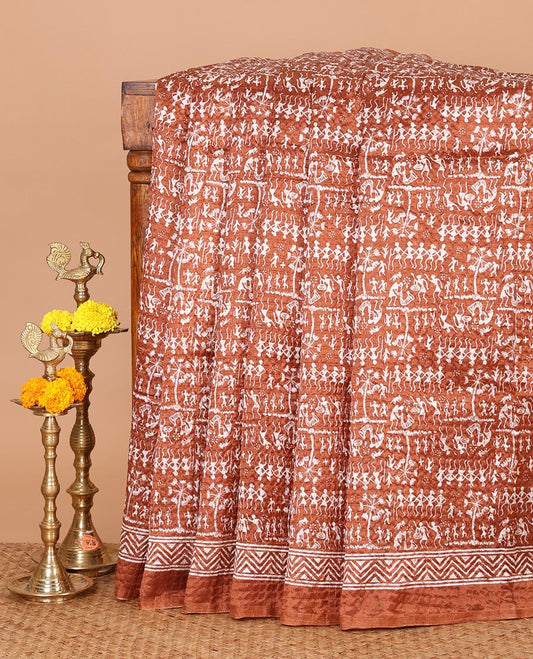 Rust batik-style warli printed Litch crushed saree, batik chevron border, floral-geometric printed pallu & triangle motif blouse