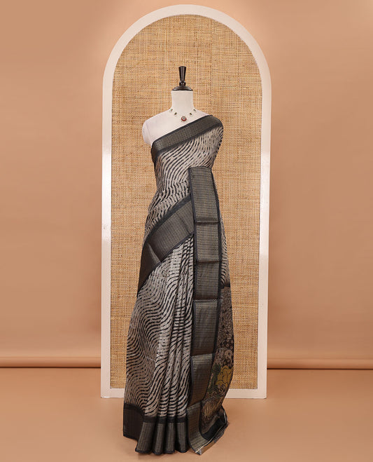 Chikku lehariya stripes printed semi-jute saree, contrast geometric zari border, printed pallu, & black blouse of print & zari work