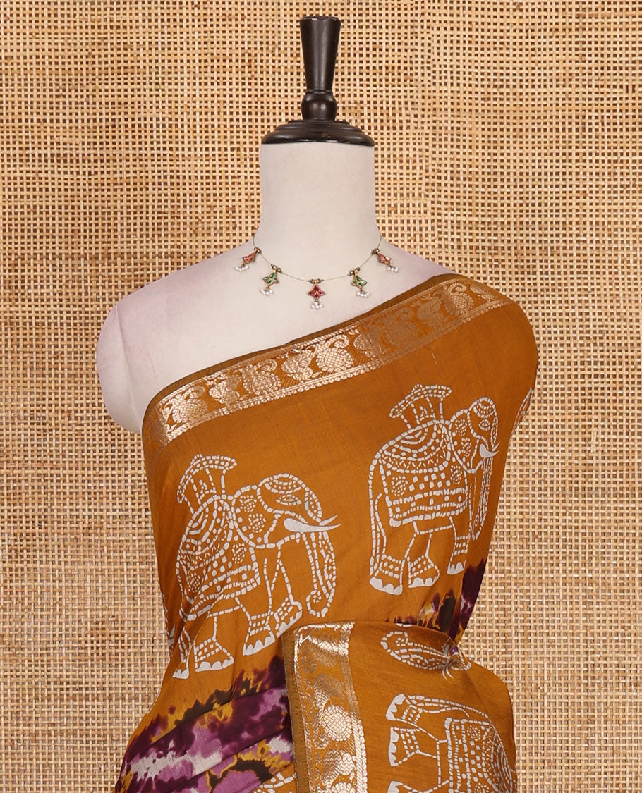 Purple-mustard shibori printed muslin cotton saree, contrast batik elephant print border of zari annam, batik elephant pallu, and contrast polka dots print blouse