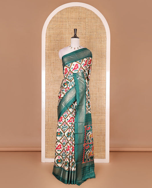 Half-white and green buttas enclosed jaal patterned patola-inspired pochampally dola silk saree, contrast green zari border, patola elephant pallu, and contrast blouse