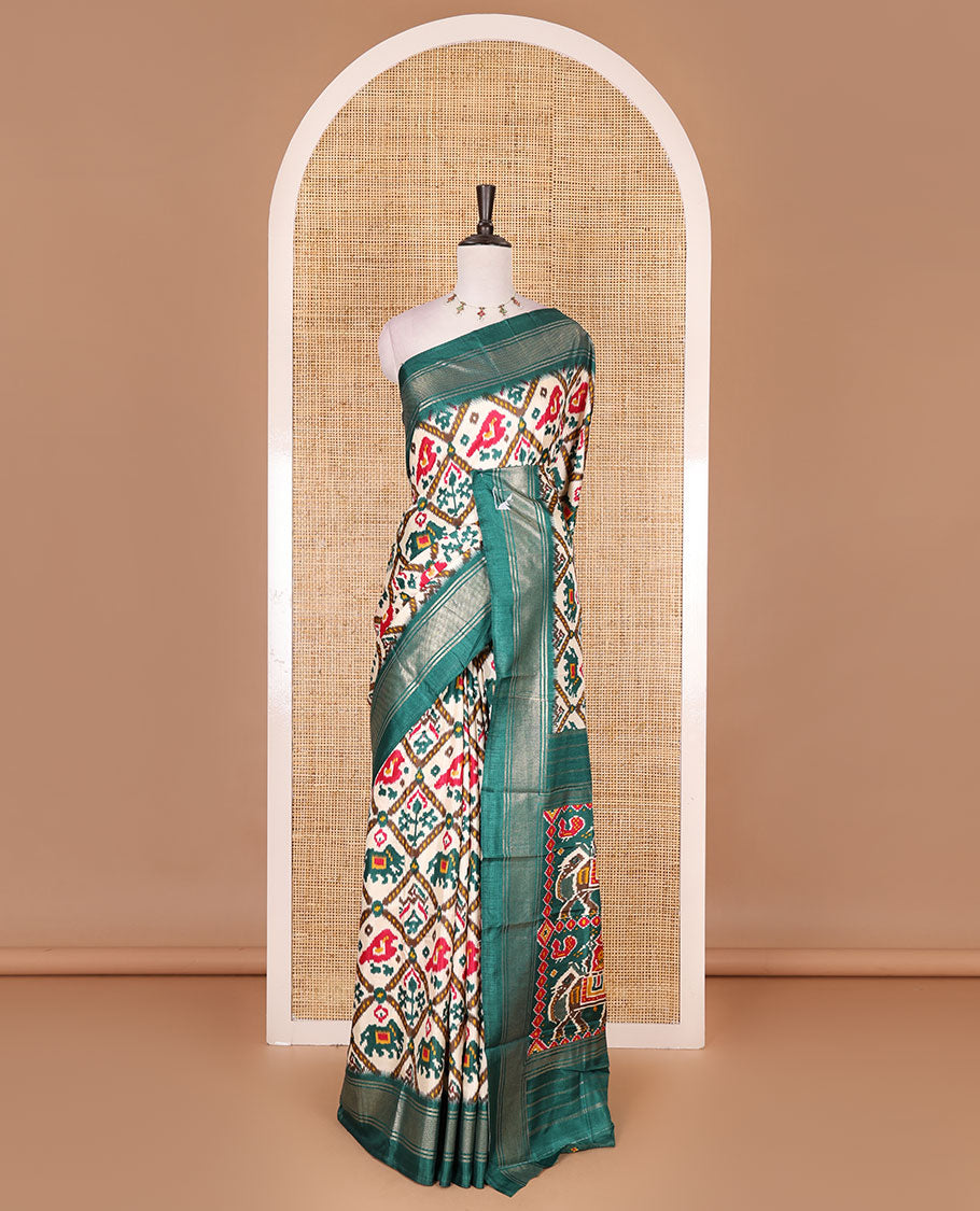 Half-white and green buttas enclosed jaal patterned patola-inspired pochampally dola silk saree, contrast green zari border, patola elephant pallu, and contrast blouse