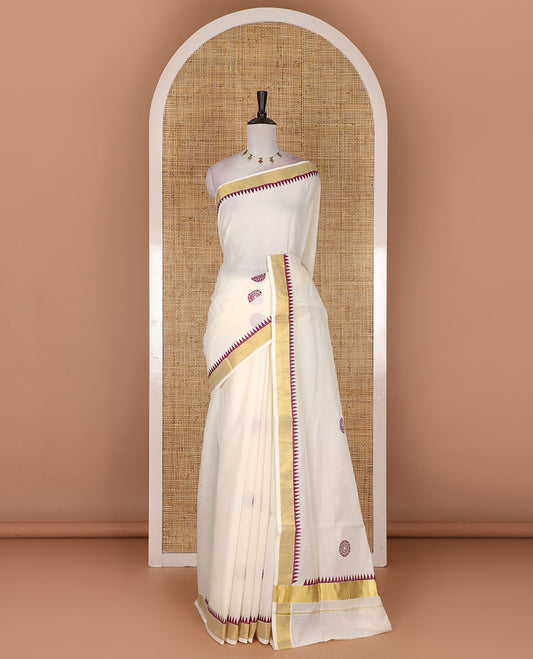 Half-white and maroon chakram motifs printed Kerala cotton saree, temple gold zari border, gold zari pallu, and matching blouse