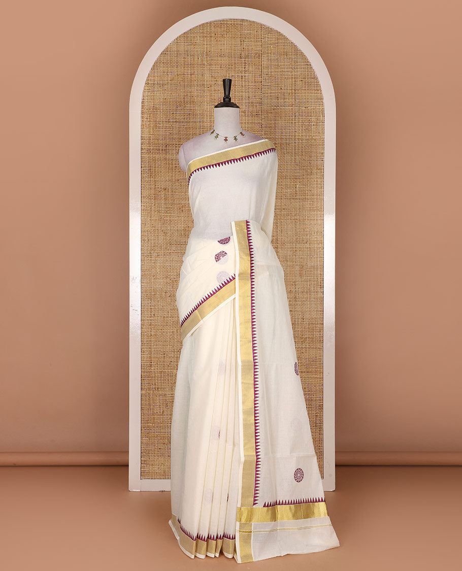 Half-white and maroon chakram motifs printed Kerala cotton saree, temple gold zari border, gold zari pallu, and matching blouse