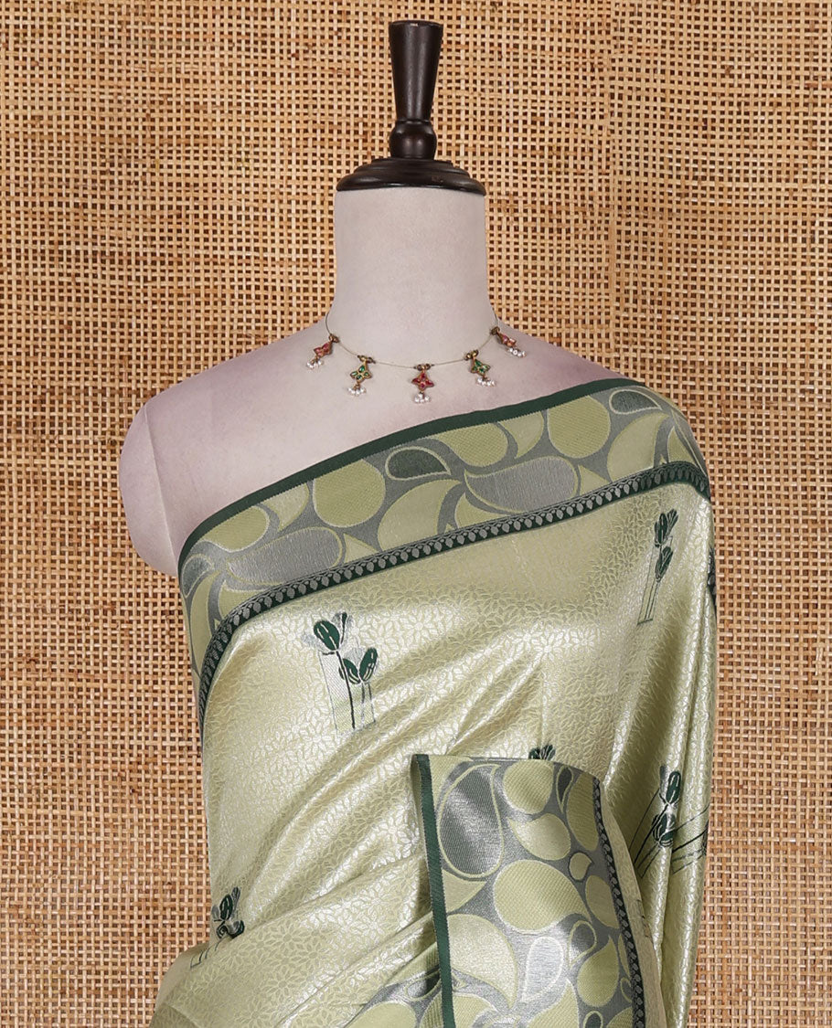 Pista green jacquard kanchi silk saree, contrast border, and pallu steeped with paisley motifs with contrast zari design blouse