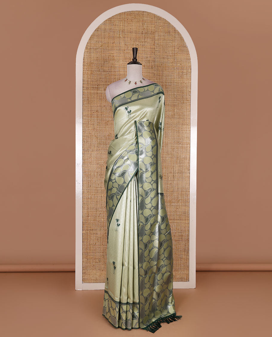 Pista green jacquard kanchi silk saree, contrast border, and pallu steeped with paisley motifs with contrast zari design blouse