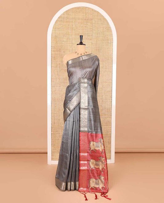 Grey striped semi-tussar saree, traditional zari border of floral creeper designs, contrast pallu of Pichwai cow print, and contrast Pichwai cow printed blouse