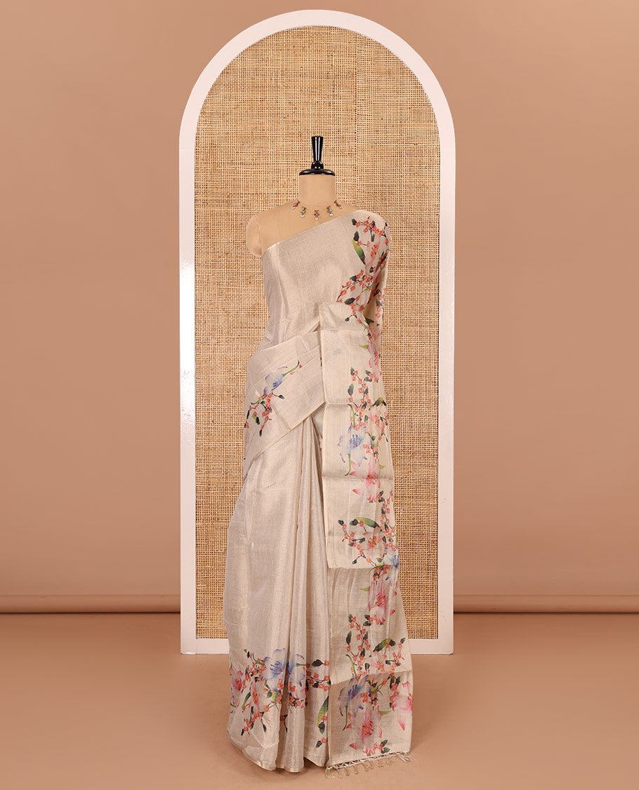 Cream plain tissue saree with hand painting style floral motifs printed border, and pallu and a printed blouse