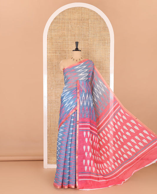 Borderless grey ikkat chevron patterned linen cotton saree, contrast zari piping border, ikkat buttas pallu, and a contrast ikkat buttas blouse