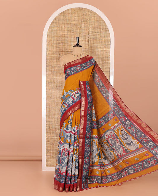 Mustard kalamkari ancient human figurines machine-printed muslin cotton saree, contrast traditional design zari border, kalamkari printed pallu, and contrast floral motifs and zari bordered blouse