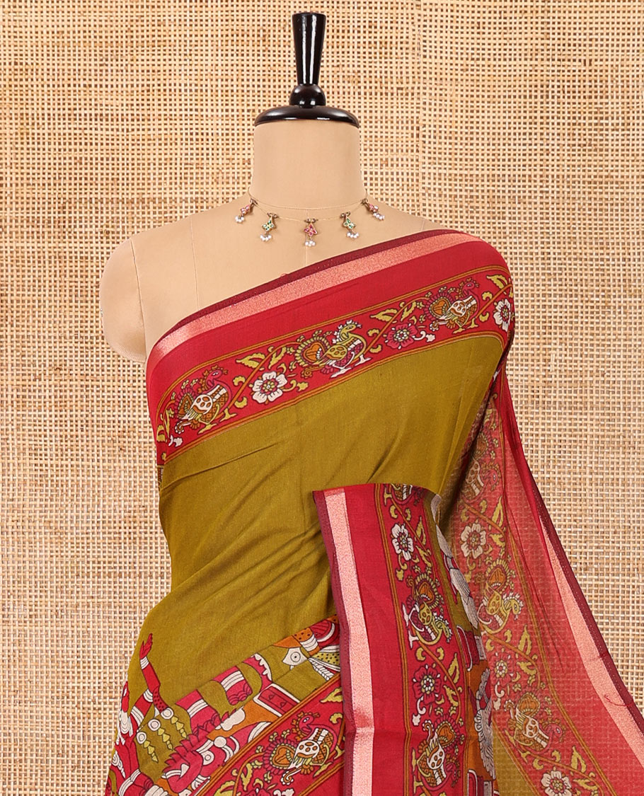 Mehendi green human figurines printed muslin cotton saree, contrast floral-peacock printed border of piping work, kalamkari printed pallu, and a contrast blouse of flower motifs print