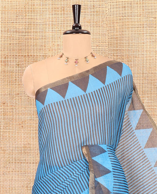 Blue vertical stripes printed linen cotton saree, a temple-printed border, big polka dot printed pallu, and a printed blouse