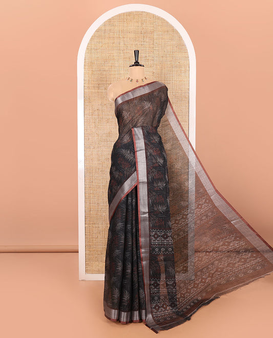 Black Printed Linen Cotton Saree Adorned with Leaf Motif Prints, Complemented by a Contrast Bavanji Border, Featuring a Geometric Printed Pallu, Paired with a Subtle Matching Blouse