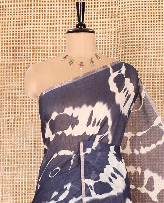 Borderless Navy Blue Linen Cotton Saree Accentuated with Shibori Prints, Complemented by Contrast Pallu Steeped with Floral Vine Print, and Paired with a Contrast Floral Printed Blouse