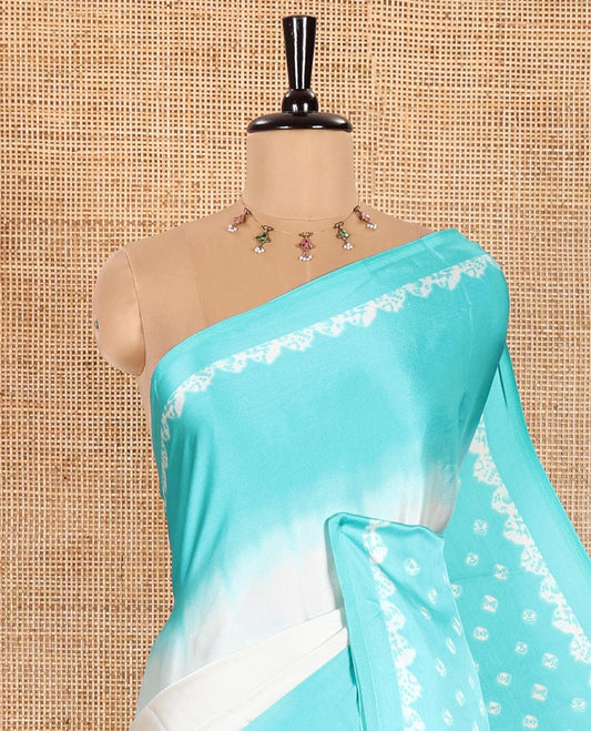 Cream and Sea Green Satin Crepe Saree Decked Up with Shibori Prints, Complemented by Contrast Shibori Printed Border, Pallu Decked Up with Shibori Prints, and Paired with a Plain Blouse