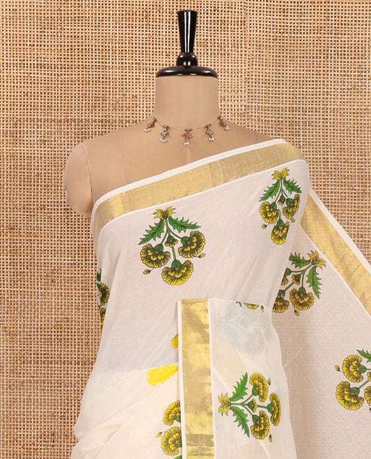 Cream and Yellow Kerala Cotton Saree, Detailed with Bunch of Floral Motifs Printed on Its Body, Subtle Zari Border, Pallu Features a Big Bunch of Floral Motifs Print, and Paired with a Matching Blouse