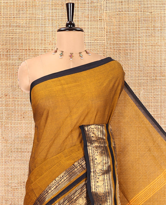 Mustard Plain Chettinad Cotton Saree, Complemented by a Contrast Rettai Pettu One-Sided Zari Border of Temple, Paisa, Elephant, and Peacock Designs, Subtly Striped Pallu, and Paired with a Matching Blouse